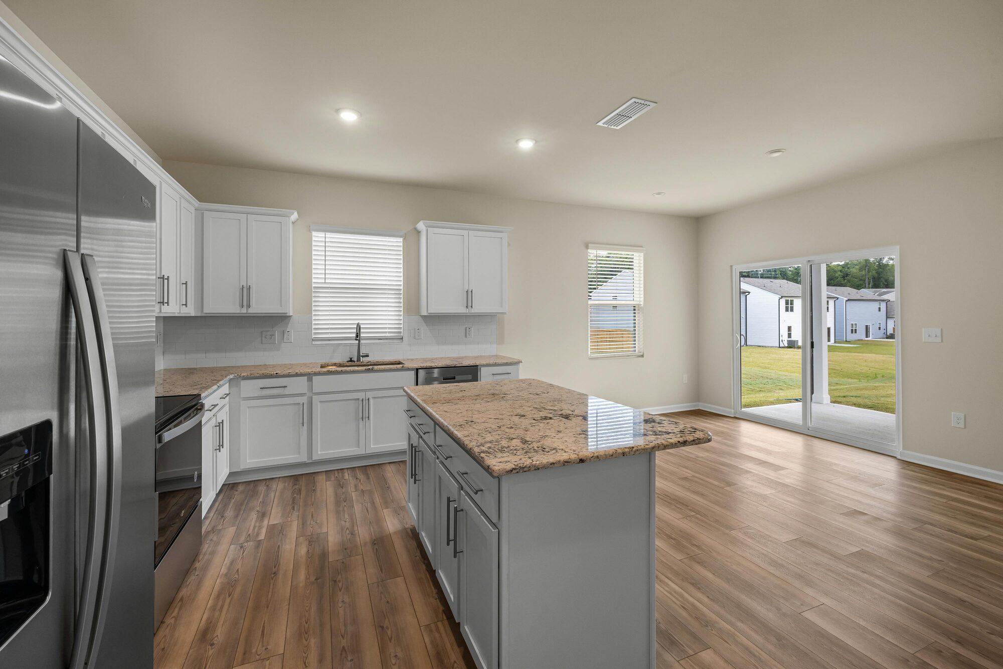 Large open kitchen with backyard view in a custom-built Isanti, MN home by Willet Remodeling and Construction. Large open kitchen with backyard view in a custom-built Isanti, MN home by Willet Remodeling and Construction.