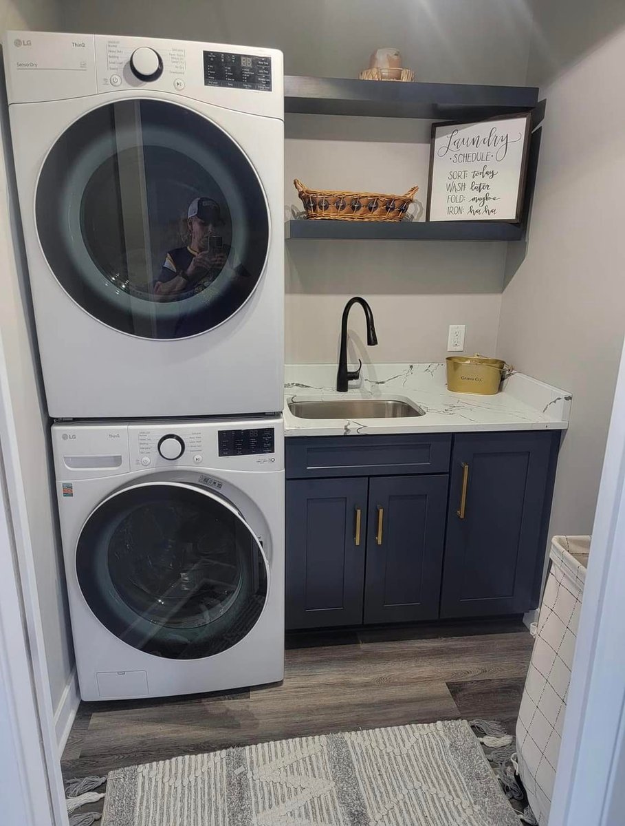 Efficient laundry space with built-in sink and LG appliances in Minnetonka, MN custom home by Willet Remodeling and Construction.