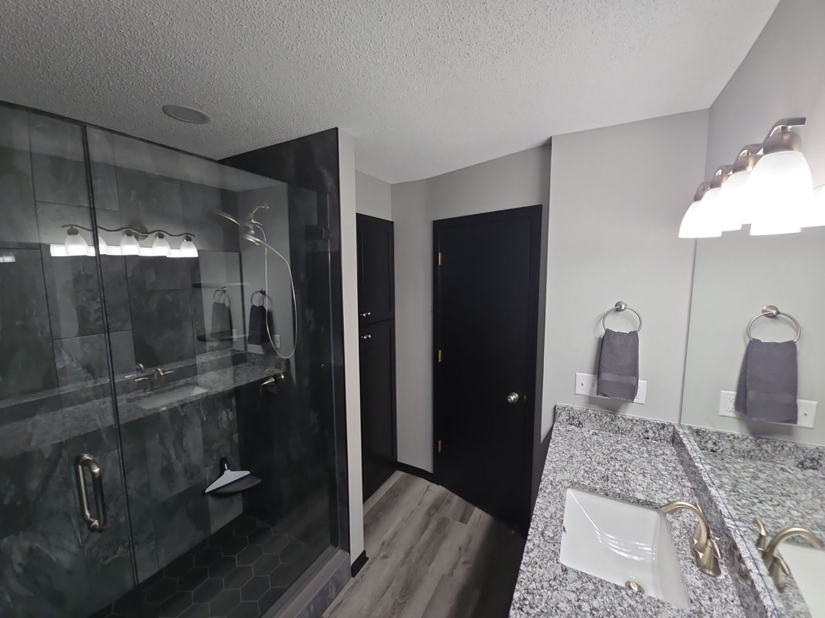 Luxury bathroom remodel with large walk-in shower and granite countertops in Minneapolis, MN by Willet Remodeling and Construction.