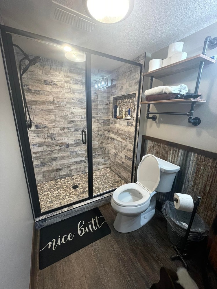 Rustic-style bathroom with barnwood tile and industrial shelves in Anoka, MN by Willet Remodeling and Construction.