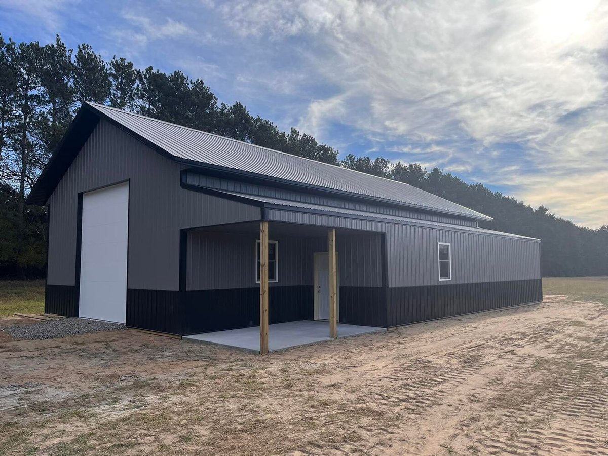 Custom metal outbuilding with overhead door constructed by Willet Remodeling and Construction in Isanti, MN.