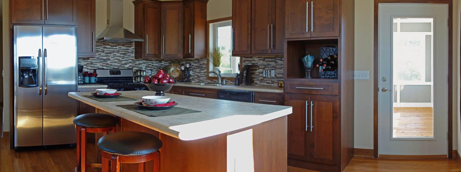 Custom kitchen with wood cabinetry and center island in Saint Paul, MN by Willet Remodeling and Construction.
