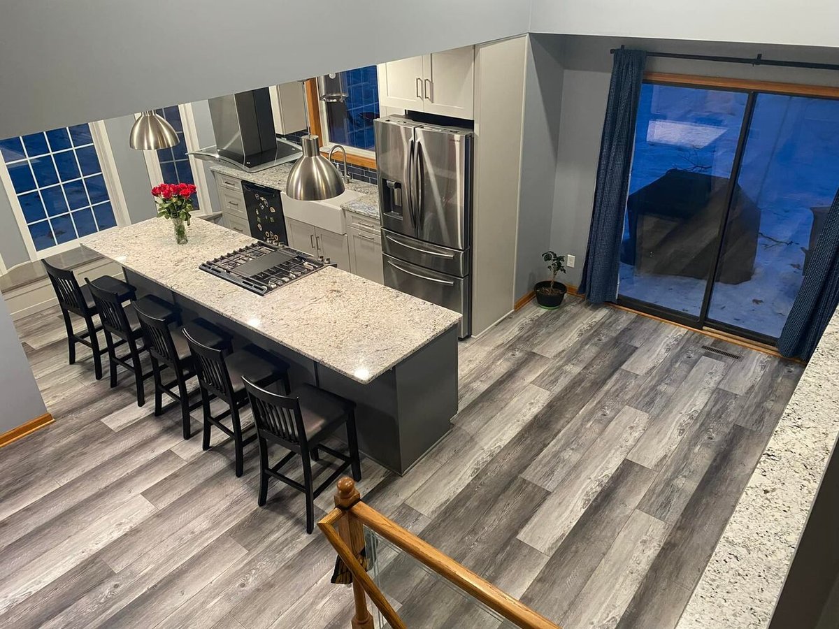 Gray and white kitchen with sliding door access designed by Willet Remodeling and Construction in Martin Lake, MN.