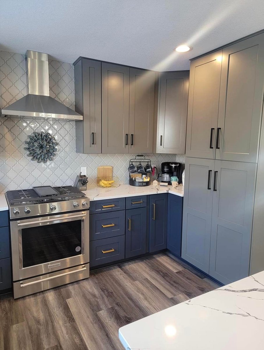 Navy and gray kitchen with gold hardware designed by Willet Remodeling and Construction in East Bethel, MN.