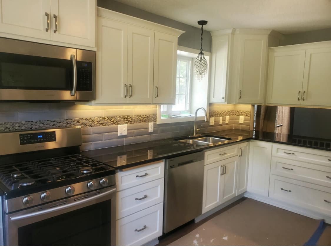 Traditional white kitchen with tile backsplash designed by Willet Remodeling and Construction in Ramsey, MN.