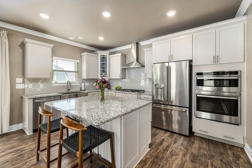 Stock Photo of Bright custom kitchen with white cabinetry and center island in Ham Lake, MN.