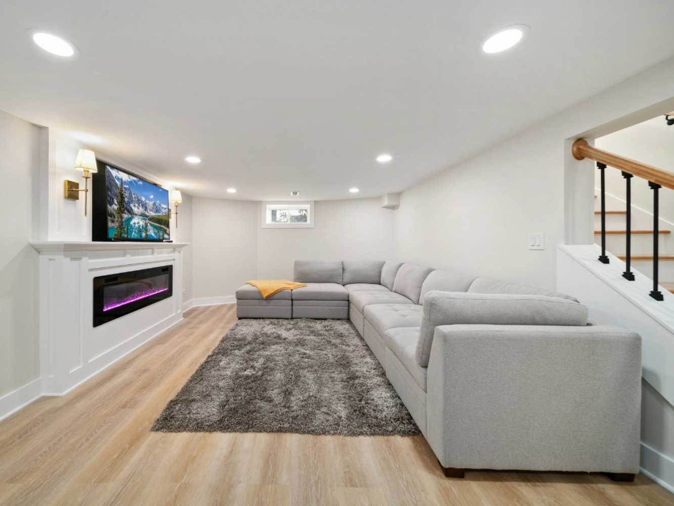 Stock Photo of Bright finished basement remodel with modern electric fireplace in Minneapolis, MN.