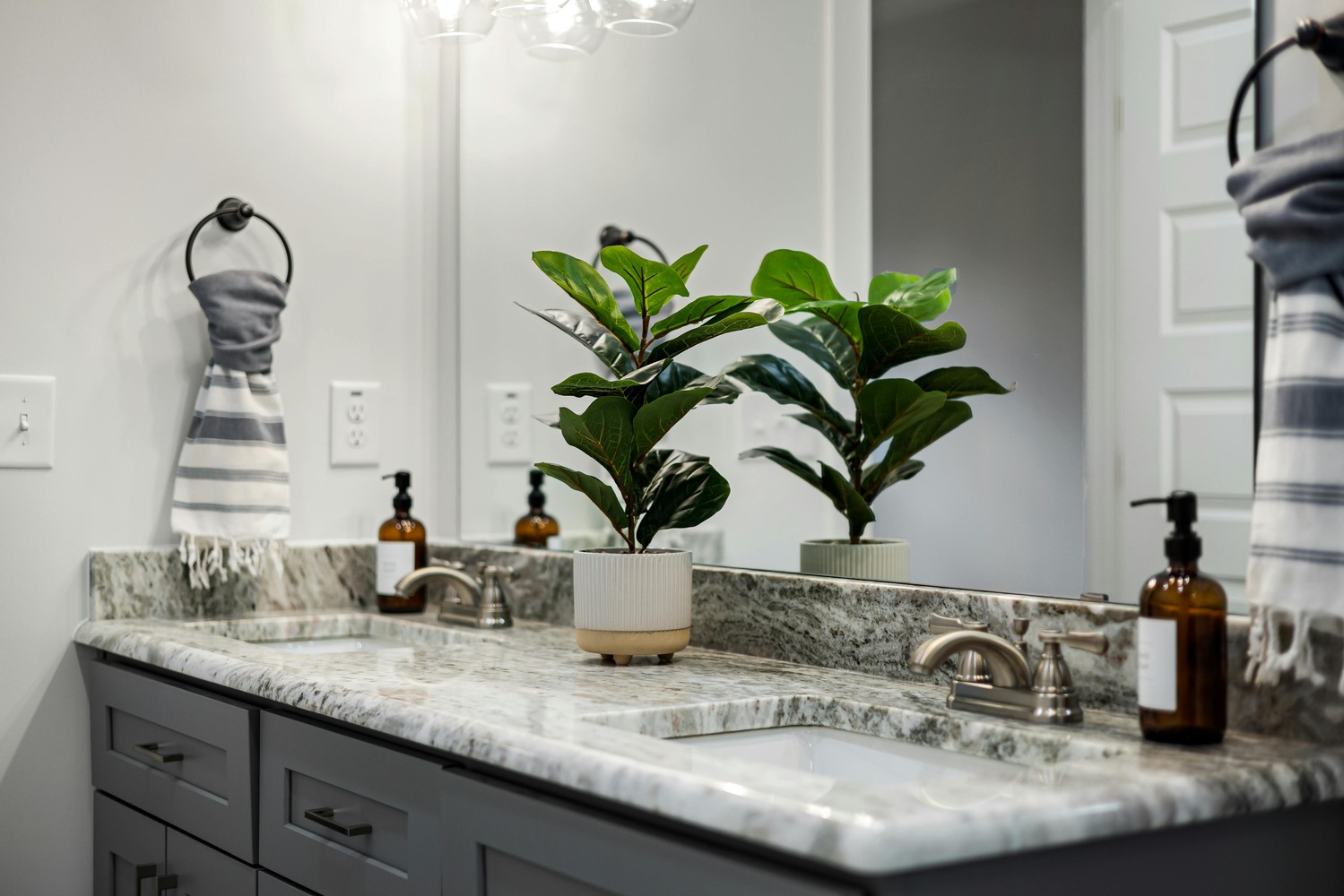 Stock Photo of Double vanity bathroom with granite counters and soft lighting in Ramsey, MN.