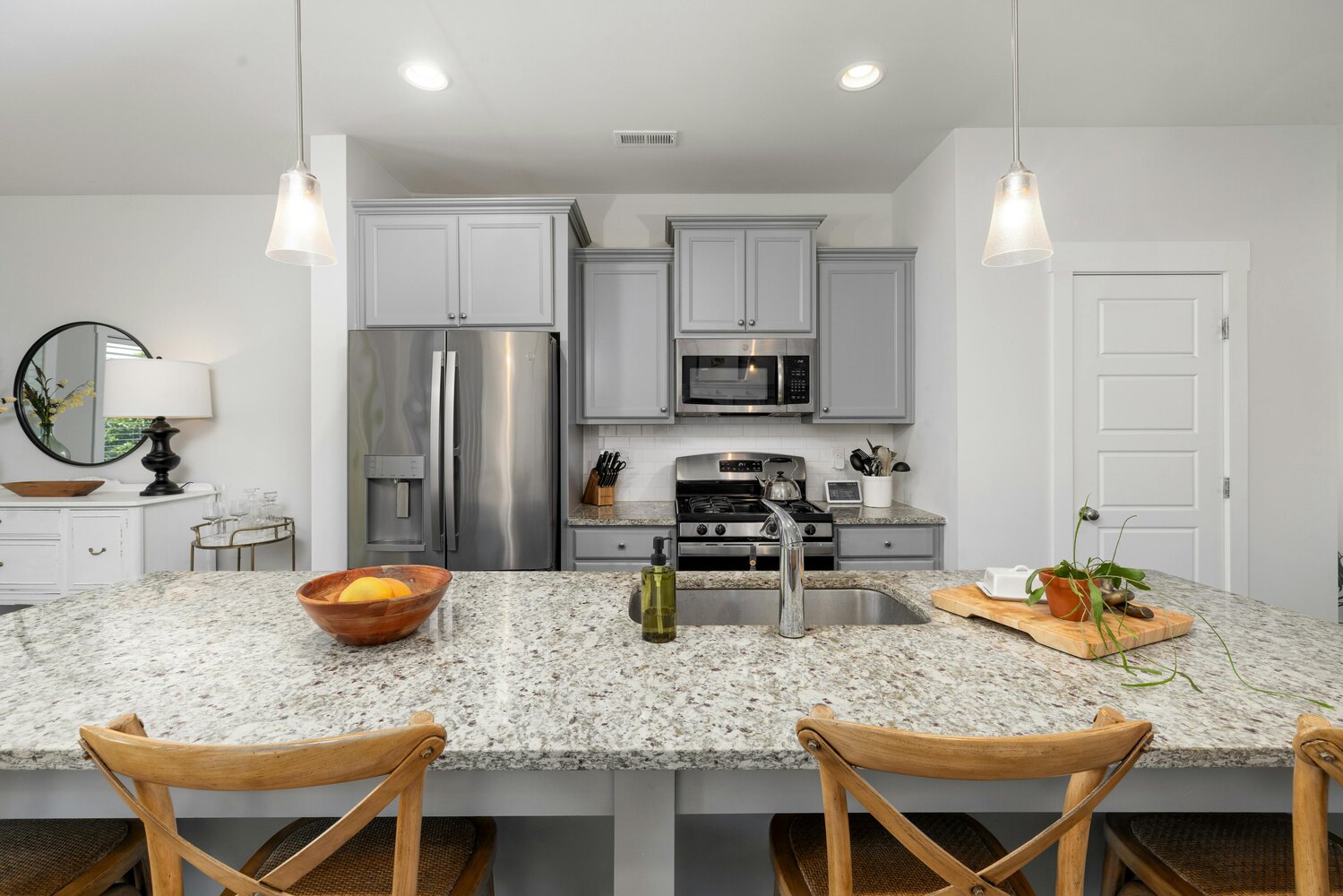 Stock Photo of Kitchen island with pendant lights and granite countertops in an Isanti, MN custom home.
