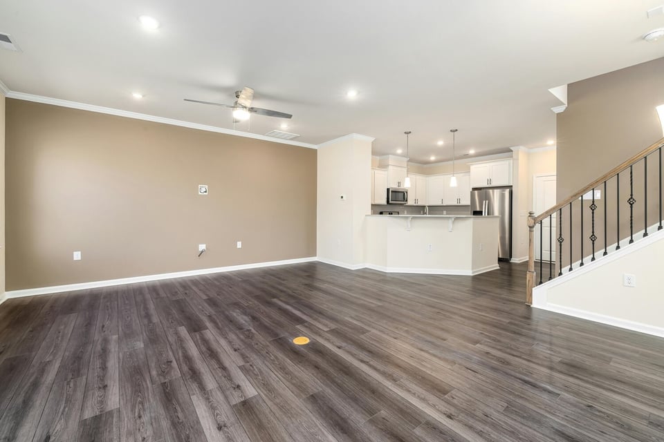 Stock Photo of Open floor plan living area with dark wood flooring in Cedar, MN.
