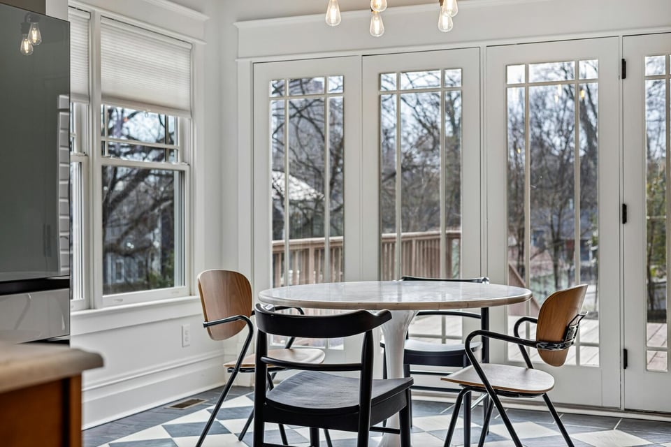 Stock Photo of Sunlit breakfast area featuring large windows and chic decor in Edina, MN.