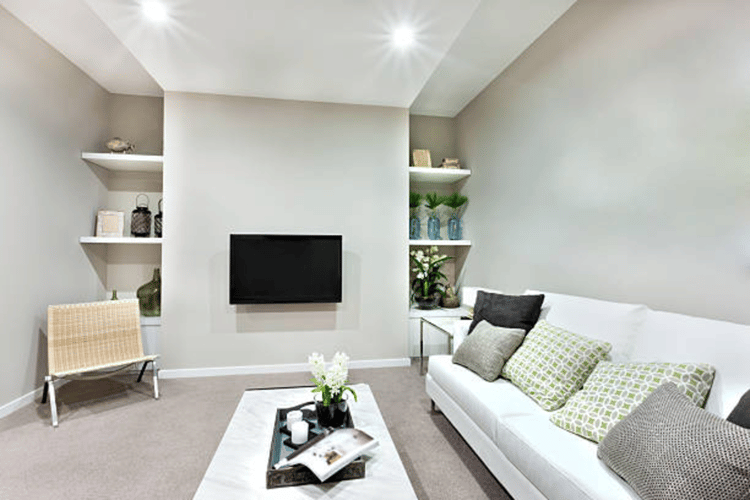 Bright basement living space with white couch and wall mounted tv