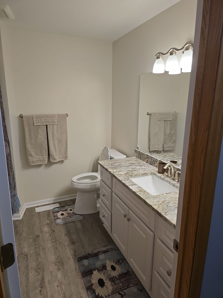 Bathroom remodel in Ham Lake, MN featuring granite countertops and luxury vinyl flooring by Willet Remodeling and Construction.