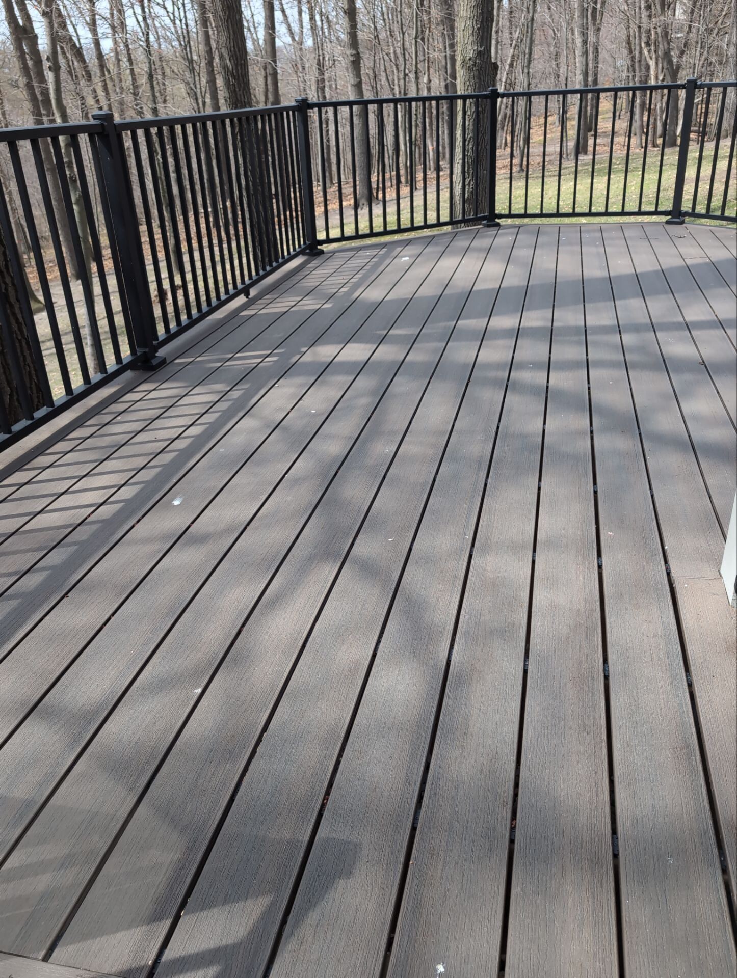 Composite deck flooring with black aluminum railing system