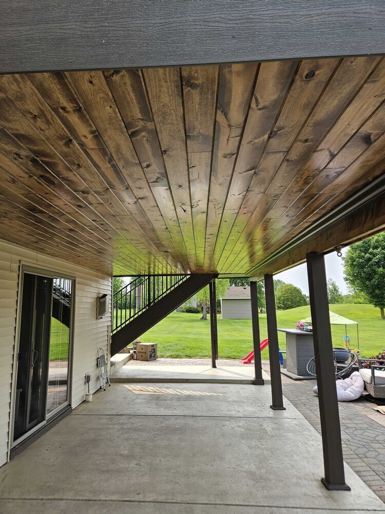 Tongue and groove wood ceiling finish under raised deck by Willet Remodeling and Construction in Saint Paul, MN.